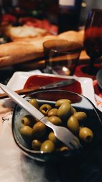 High angle view of green olives in bowl