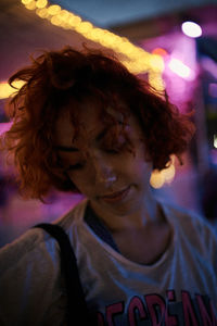 Young alternative redhead girl's portrait in a purple light