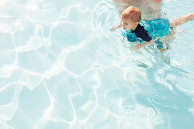 High angle view of boy swimming in pool