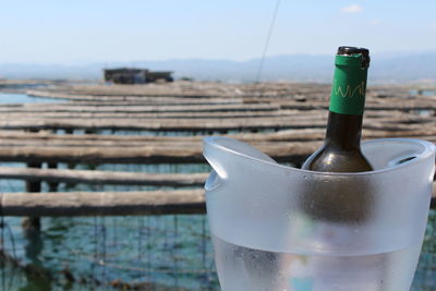 Close-up of drink bottle against sky