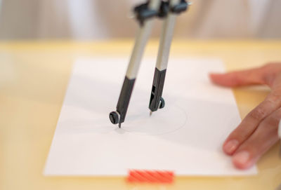 Cropped hand of person working on table