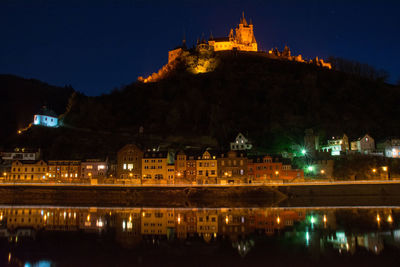 Low angle view of castle on mountain at cochem during night