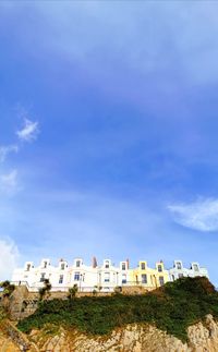 Low angle view of buildings against blue sky