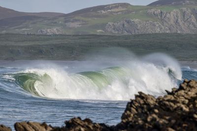Scenic view of sea with breaking waves