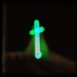 Close-up of illuminated lamp over black background