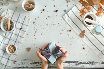 High angle view of woman holding food on table