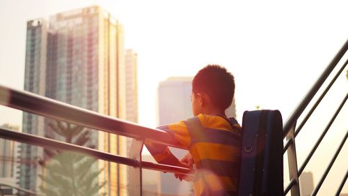 Low angle view of child against clear sky