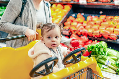 Portrait of cute baby girl in store