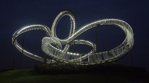 Illuminated ferris wheel at night