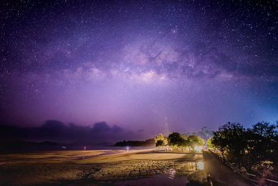 Scenic view of landscape against sky at night