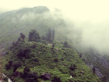 Scenic view of mountains against cloudy sky