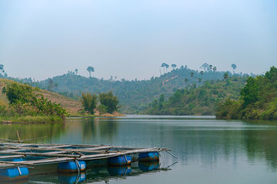 Scenic view of lake by trees against sky