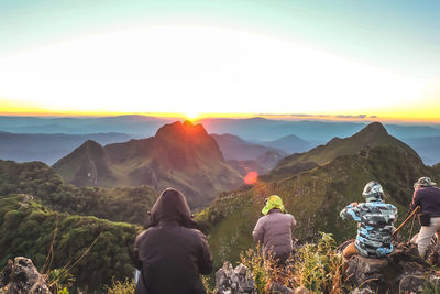 Friends on mountain during sunset