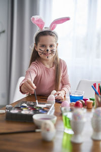 Girl with painted face at home