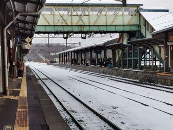 Railroad station platform in city during winter