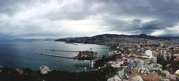 High angle view of city by sea against sky