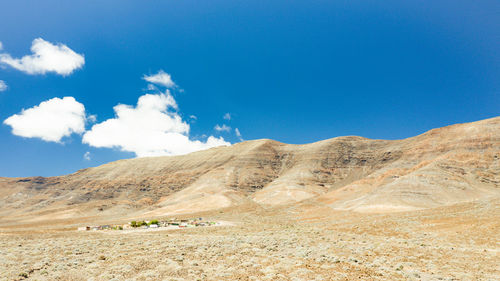 Scenic view of mountains against blue sky