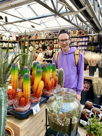 Young guy with rainbow cacti 