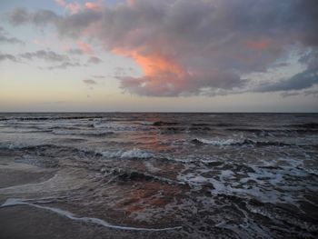 Scenic view of sea against cloudy sky