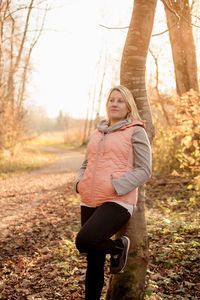 Full length portrait of woman in forest during autumn