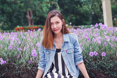 Portrait of beautiful young woman with purple flowers