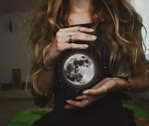 Midsection of woman holding smart phone