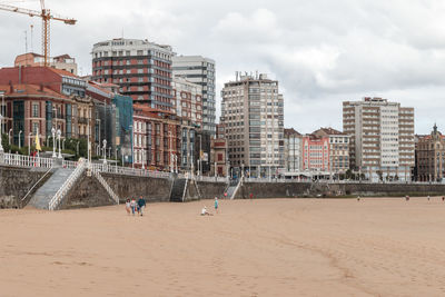 Buildings at beach against sky in city