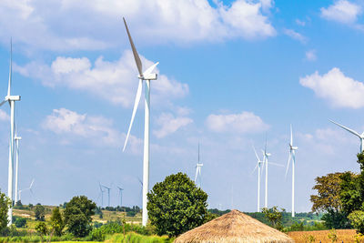 Windmill on field against sky