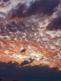 Low angle view of dramatic sky during sunset