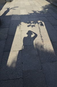 Shadow of man on tiled floor