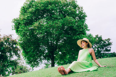 Low angle view of woman sitting on grass