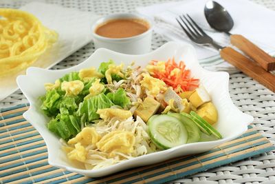 Asinan betawi. indonesian raw vegetable and yellow tofu bean curd with tangy peanut dressing 