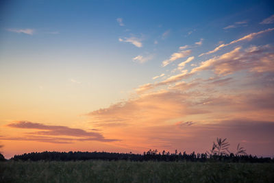 Scenic view of field against sky during sunset