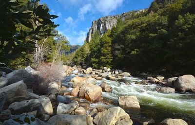 Rocks in water against sky