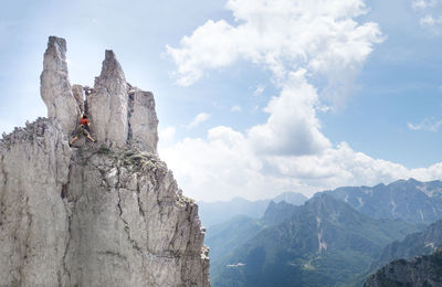 Low angle view of man on cliff against sky