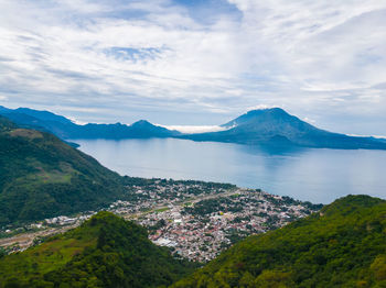 Panoramic view of sea and mountains against sky