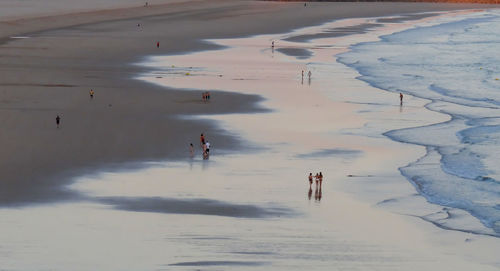 High angle view of people walking on beach