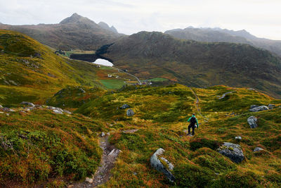 Man standing on mountain against sky