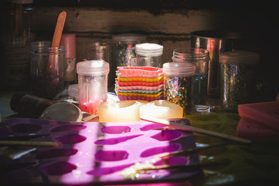 Close-up of multi colored bottles on table