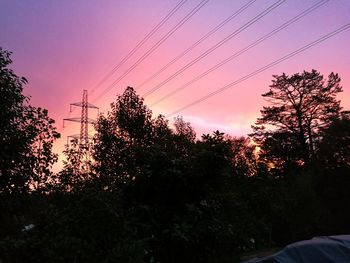 Silhouette trees against sky at dusk