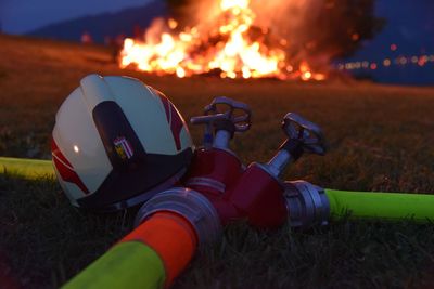 Close-up of camera on field at night