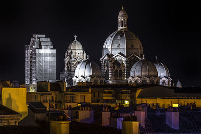 View of buildings in city at night