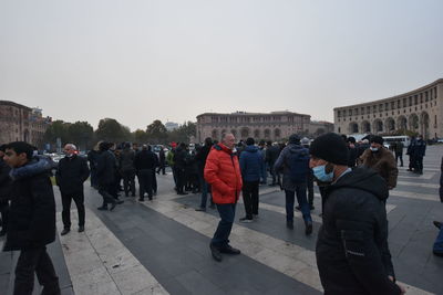 Group of people in front of built structure against clear sky