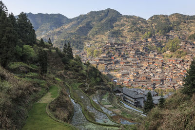 High angle view of road by buildings against sky