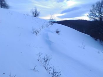 Scenic view of snow covered landscape against sky