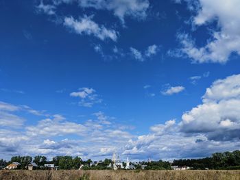 Scenic view of field against blue sky