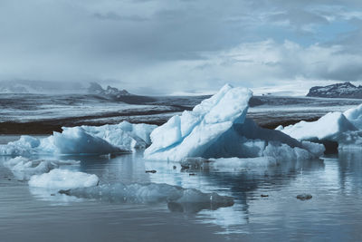 Scenic view of frozen lake against sky during winter