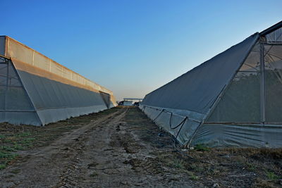 Tent on field against clear blue sky