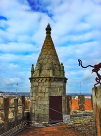 Low angle view of historical building against cloudy sky