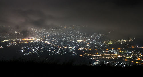 High angle view of illuminated buildings in city at night